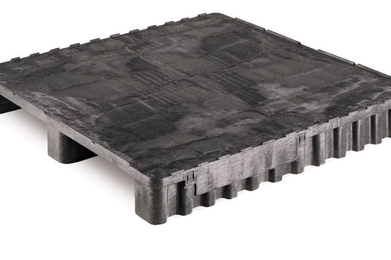 A black plastic pallet stands on a white background.