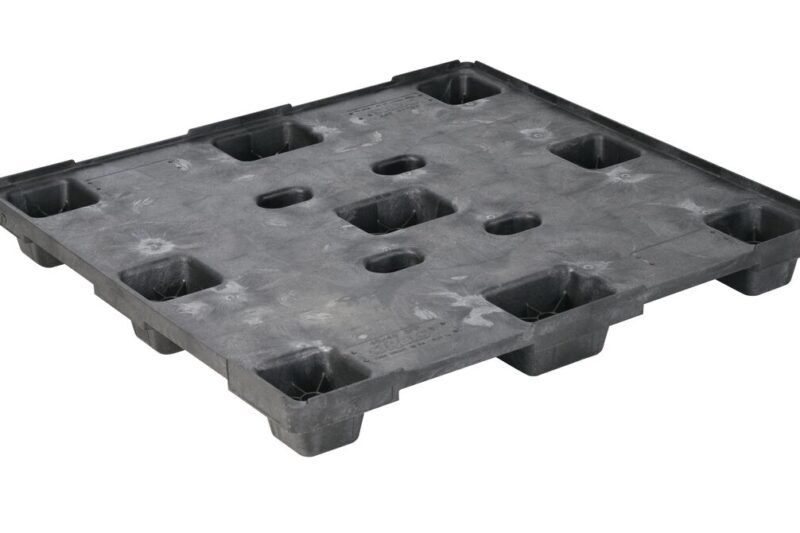 A black plastic pallet with holes on it.