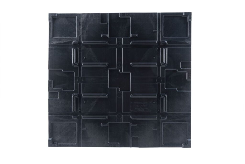 An image of a black plastic pallet with squares.