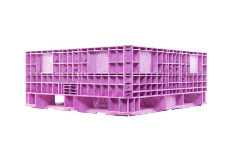 A collapsible pink plastic bulk bin