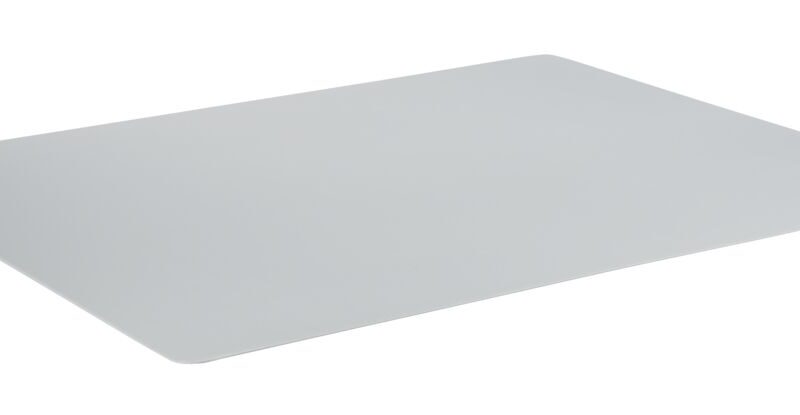 A gray plastic cutting board sits on a white surface.
